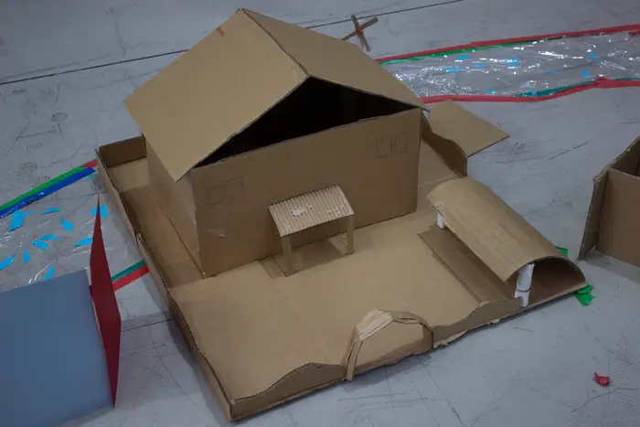 A cardboard architectural model of a house