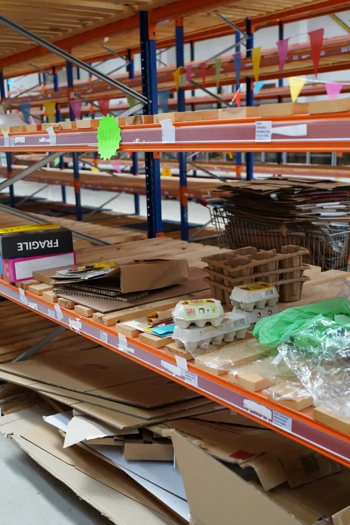 Shelves stacked with found cardboard and materials
